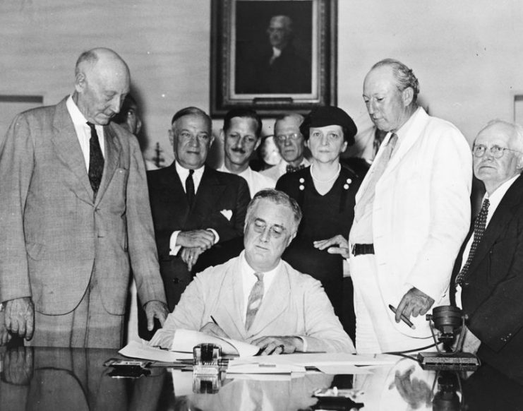 Roosevelt signs the Social Security Act into law, August 14, 1935