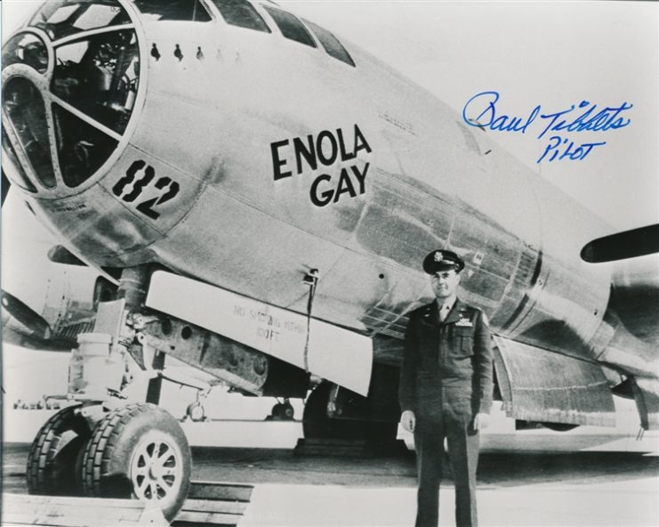 American bomber pilot of the Enola Gay, which dropped the first atomic bomb on Hiroshima, August 6, 1945. S.P., 8″ x 10″ b/w, a modern print of a view of Tibbets standing before the Enola Gay, signed at upper right in blue ink, adding his role: “Pilot”-Photo: Alexander Historical Auctions.