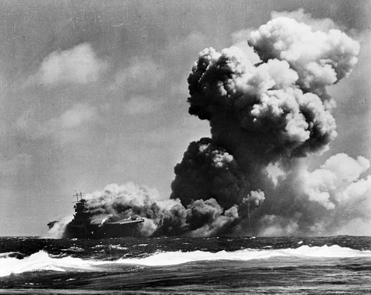 The U.S. aircraft carrier USS Wasp (CV-7) burning after receiving three torpedo hits from the Japanese submarine I-19 east of the Solomons, 15 September 1942.
