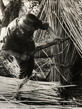 A German soldier finds an abandoned Russian hideout during a patrol along the mouth of the Dnieper River. Ukraine, October 15, 1941.