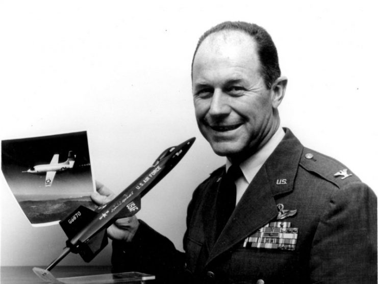 Col. Charles S. Yeager, poses with a model of the North American X-15 high speed, high-altitude research aircraft.
