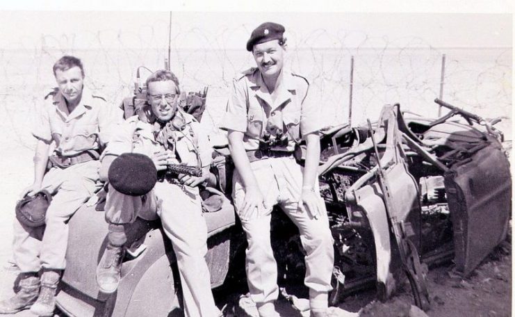 D Coy’s Jimmy Justice, Colin Shasher, and Major Roy Jackson resting after patrolling along the Scrubber Line, Sheikh Othman. The vehicle was destroyed by a landmine.Photo: Brian Harrington Spier CC BY-SA 2.0