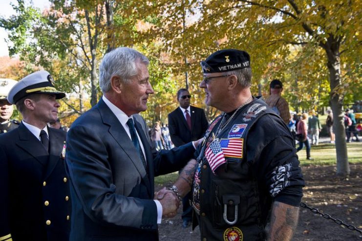 The former Defense Secretary Chuck Hagel shakes hands with a Vietnam War veteran after a Veterans Day ceremony at the Vietnam Veterans Memorial in Washington, D.C., Nov. 11, 2014.