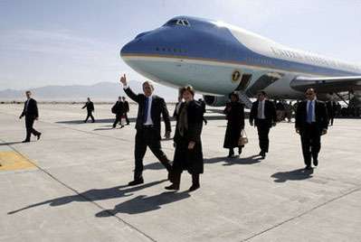 President George W. Bush and First Lady Laura Bush walk on the parking ramp as Air Force One sits at Bagram Air Base in Afghanistan, 1 March 2006.
