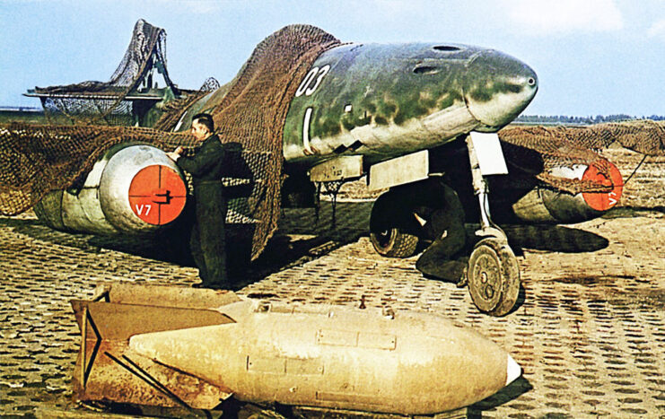 A Messerschmidt ME 262 V7 jet fighter, partly under a camouflage net, 1945. Photo by Galerie Bilderwelt/Getty Images.