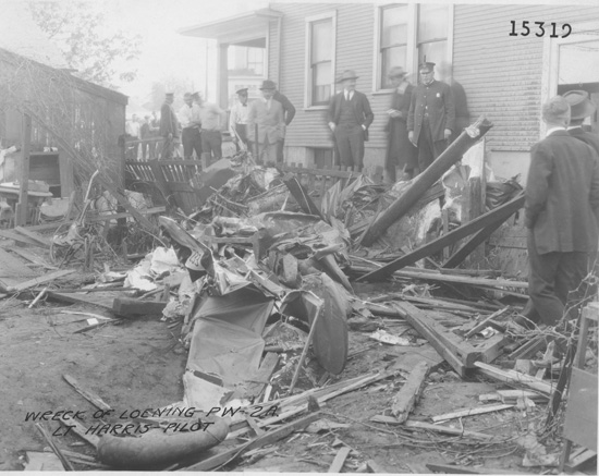 Facing a certain crash, Harris bailed out of the stricken aircraft, landing in a backyard grape arbor at a house at 335 Troy St., suffering only bruises on his legs and hand from fighting with the control stick.