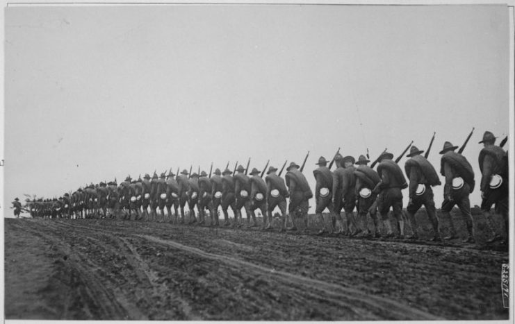 Headquarters Troop of the 27th Division, New York National Guard, silhouetted against the gathering dusk as they march to the training camp. September 5, 1917.