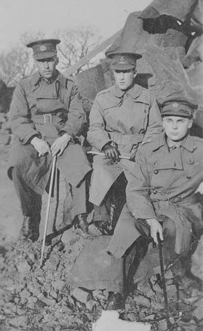 John G. Diefenbaker (future Prime Minister of Canada), John Einarsson, and Michael A. McMillan as Canadian soldiers in France 1916-17 wearing trench coats.