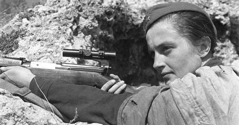 Lyudmila Pavlochenko with her rifle in a trench.