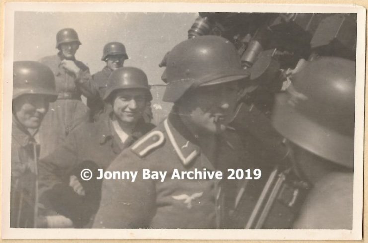 A helmeted non-commissioned officer gives orders to the crew of the formidable 128mm flak crew. © Jonny Bay Archive 2019