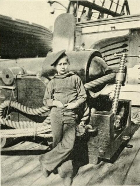 Union powder monkey standing in front of a cannon