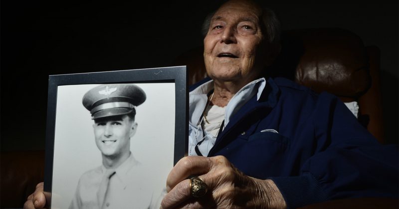 Retired Col. Ralph Parr holds a portrait of himself.