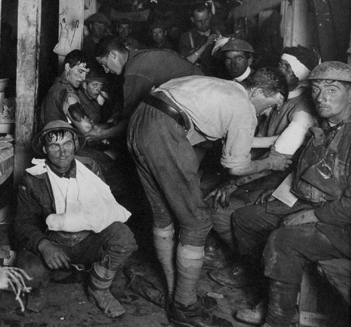 Australian Advanced Dressing Station near Ypres in 1917. The wounded soldier in the lower left of the photo has a dazed, thousand-yard stare – a frequent symptom of “shell-shock”.