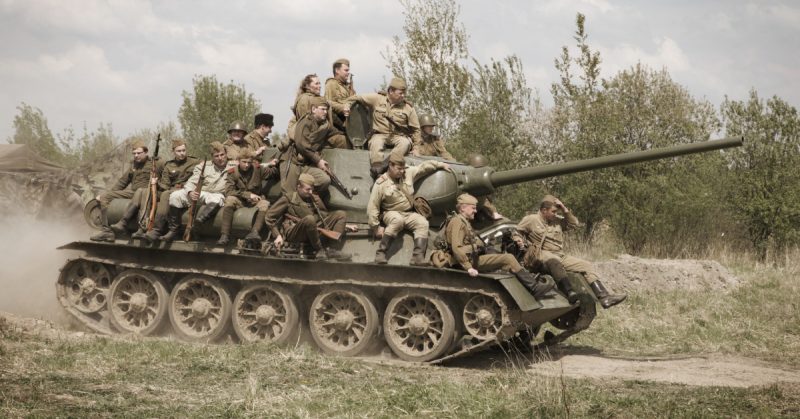 Soviet tank T-34 with group of Red Army soldiers