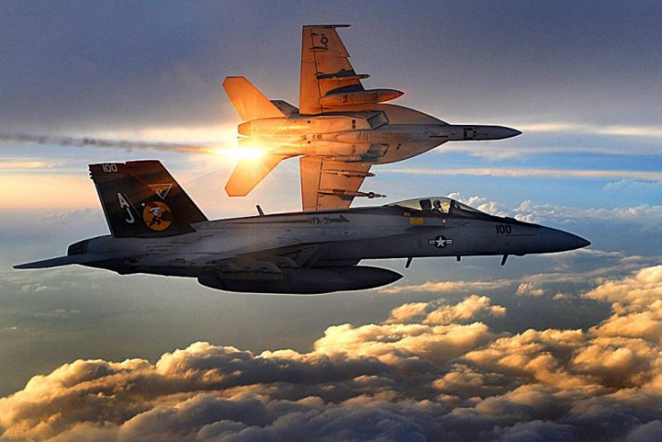 Two U.S. Navy F A-18E Super Hornets fly a combat patrol over Afghanistan in 2008. The aircraft in the background is deploying infra-red flares