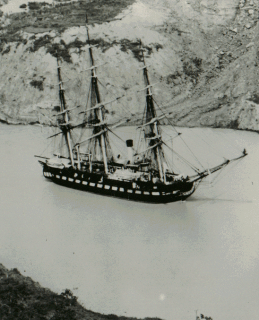 USS Constitution passing through Gaillard Cut on her Atlantic to Pacific transit of the Panama Canal, 27 December 1932. Alongside is the Canal tug Gorgona.