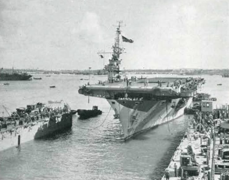 The U.S. Navy escort carrier USS Lunga Point (CVE-94) enters a floating drydock at Guam, in May 1945.