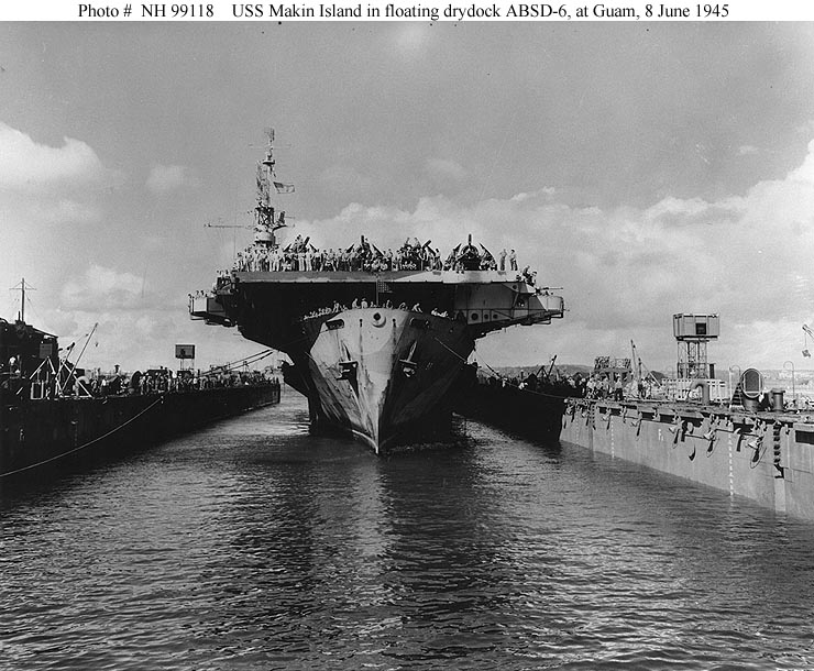 USS Makin Island (CVE-93) halfway into USS ABSD-6, at Guam, 8 June 1945