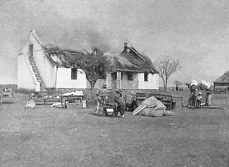 One British response to the guerrilla war was a ‘scorched earth’ policy to deny the guerrillas supplies and refuge. In this image Boer civilians watch their house as it is burned.