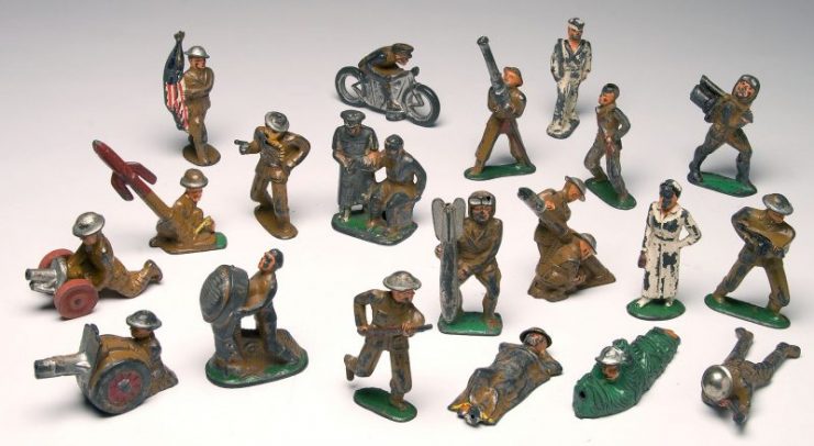 Barclay lead toy soldiers and figures, including motorcycle, canons and mortars.