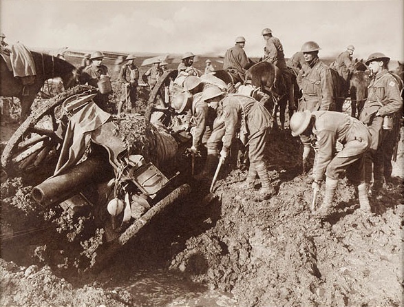 Members of the Australian 1st Division Pioneers digging out a gun belonging to the 104 Howitzer Battalion, which had been trying to haul their gun forward after the advance near Hannebeek, in the Ypres Sector.