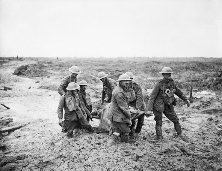 Battle of Pilckem Ridge. Stretcher bearers struggle in mud up to their knees to carry a wounded man to safety near Boesinghe, 1 August 1917.