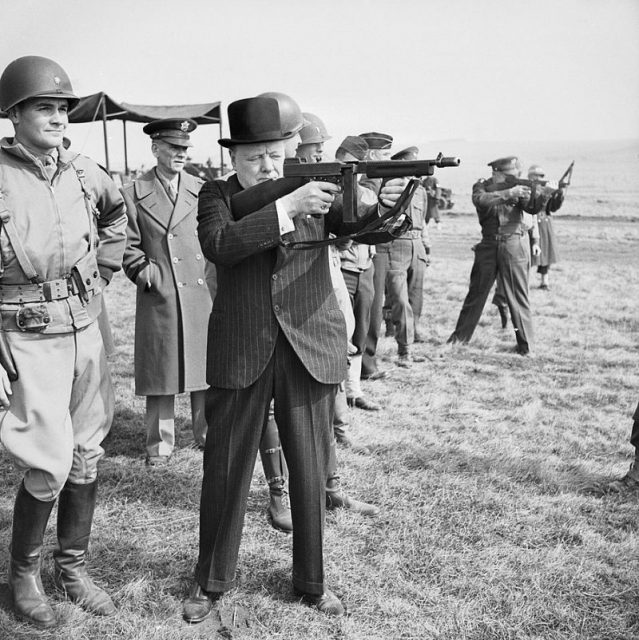 Winston Churchill fires a Thompson submachine gun alongside the Allied Supreme Commander, General Dwight D Eisenhower, during an inspection of US invasion forces, March 1944.