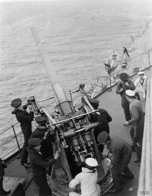 A 3 inch anti-aircraft gun in action on board the British battleship HMS Royal Oak
