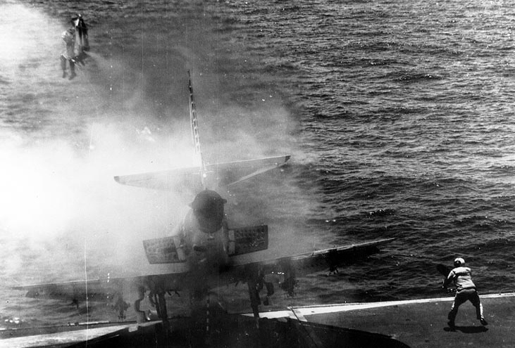 Lt. (j.g.) William Belden ejects from an A-4E Skyhawk as it rolls into the carrier’s catwalk after a brake failure on the deck of the USS Shangri-La on 2 July 1970. The pilot was recovered by helicopter.