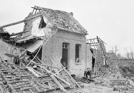 A damaged house in the village of Hamel, Nord, France on 4 July 1918 following the attack by Australian and American forces. A German machine-gun can be seen at the entrance.