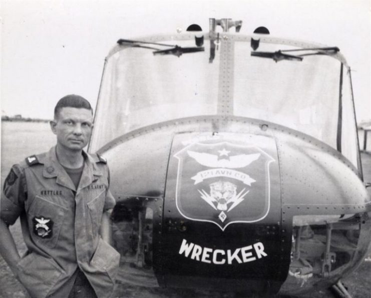 Charles Kettles stands in front of a 121st Aviation Company UH-1H Huey helicopter during his second tour of duty in Vietnam in 1969.