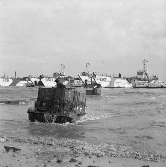 Universal Carriers of 50th Division wade ashore from LCTs on Jig beach, Gold area, 6 June 1944.