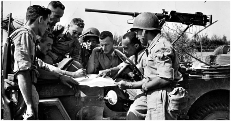 Company officers from the BEF study maps before attacking Germans along the Fifth Army front line