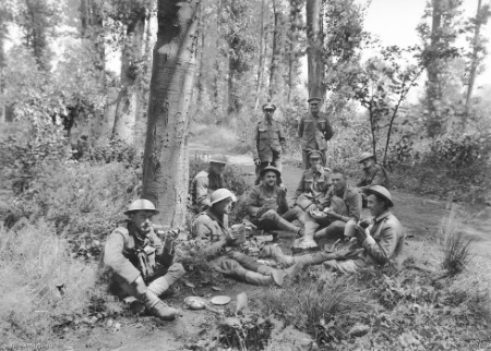 British, American and Australian troops lunching in a wood near Corbie the day before the attack.