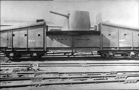 South West Africa. c. 1915. A large gun mounted on a special armoured railway truck. HMAT Trafalgar is painted on the side of the truck.