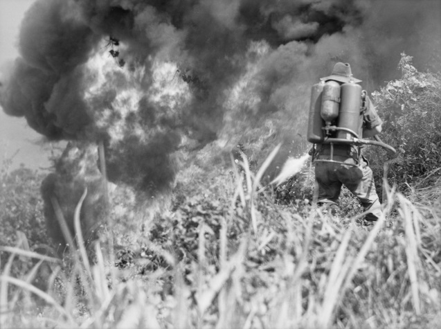 Infantryman using a flamethrower against a Japanese position in Wewak, during World War II