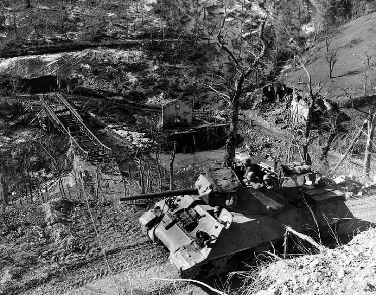 M10 of the 701st Tank Destroyer Battalion advances along a mountain road in Italy, March 3, 1945.