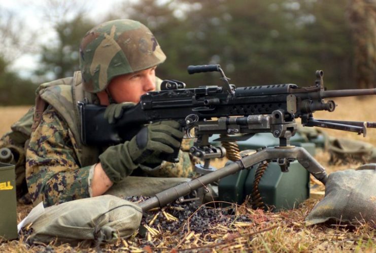 A U.S. Marine firing an M249 from an M122A1 tripod at a training range