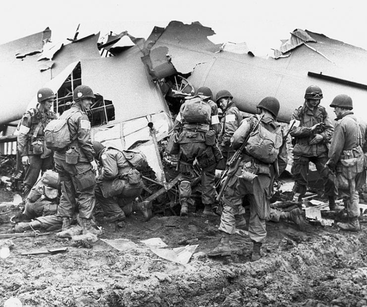 Men of the 101st Airborne Division inspect a broken glider, 1944.