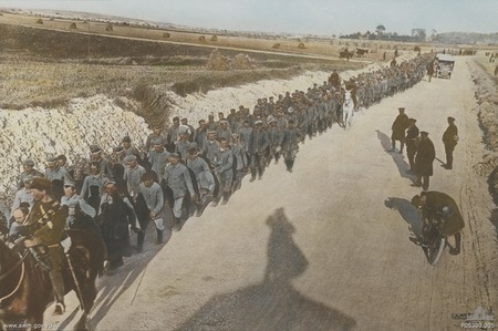 A column of German prisoners walking along the Villers Bretonneux-Amiens Road. Australian soldiers watch the prisoners.