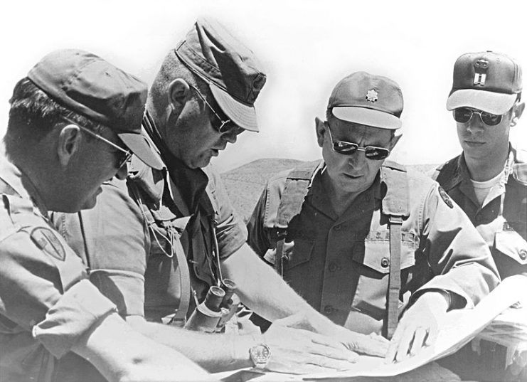 Schwarzkopf, then a colonel, consults with other officers during a training mission in California in 1977.Photo: oregonmildep CC BY 2.0