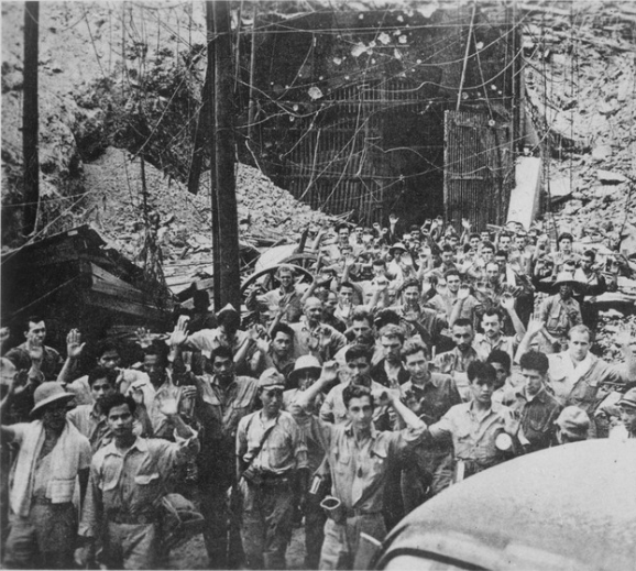 U.S. and Filipino soldiers and sailors surrendering to Japanese forces at Corregidor.