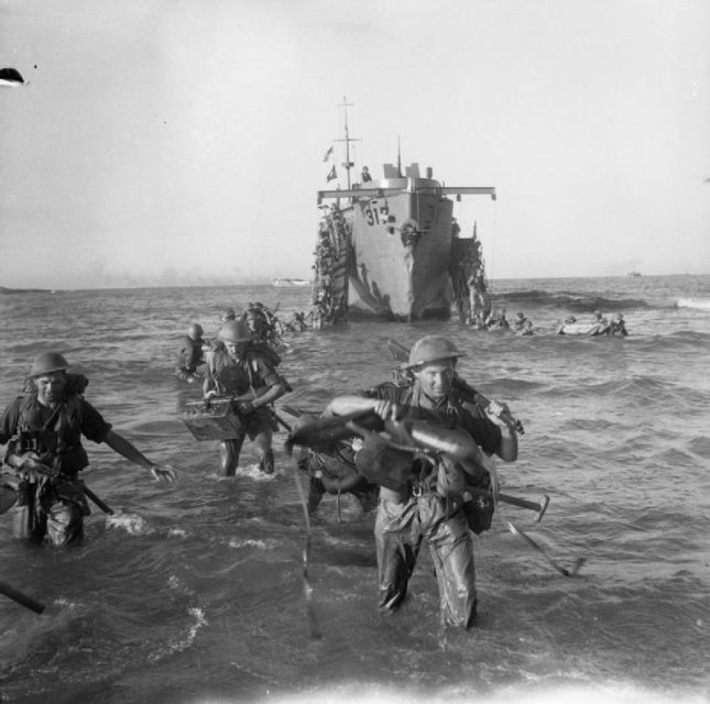 The Invasion of Sicily July 1943. Infantry from the 51st Highland Division wade ashore from a landing ship, 10 July 1943.