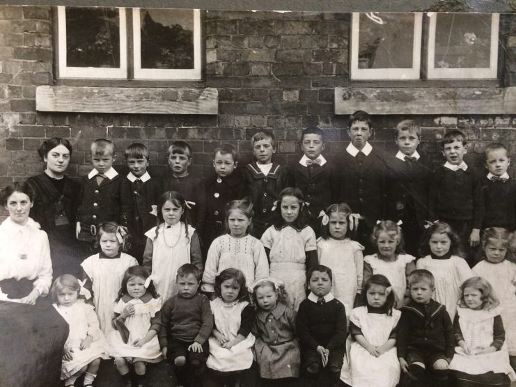 Kitty and Elsie Holderness with children at Eakring School. Credit: Hansons