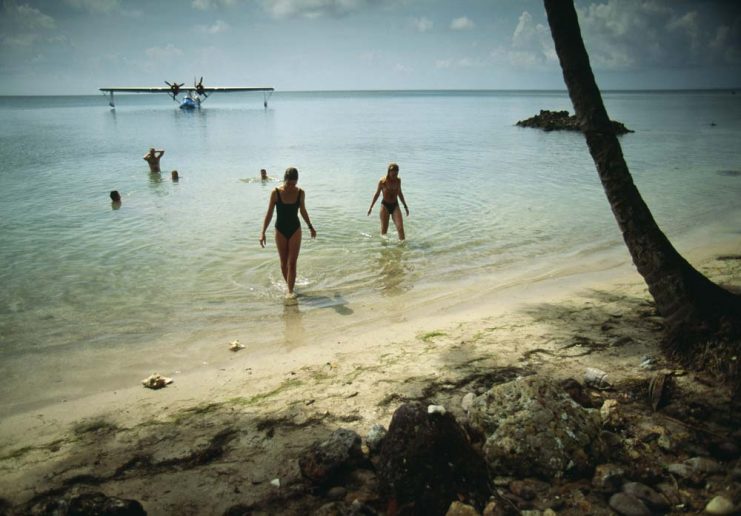 Brazil, Salvador de Bahia, Catalina PBY-5a flying boat and tourists at beach