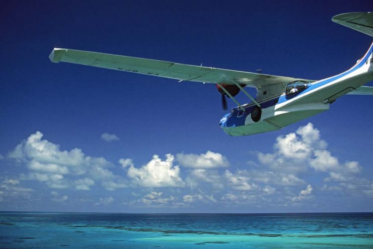 Bahamas, Bimini, Catalina PBY-5A hydroplane flying over water.