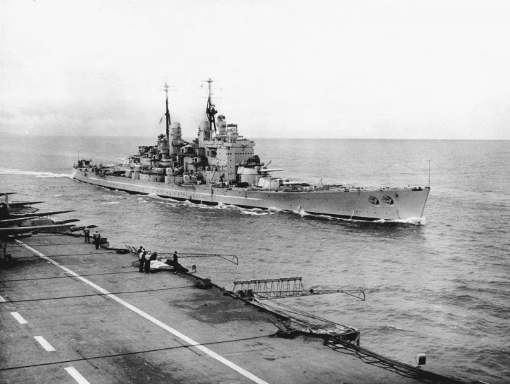 The Royal Navy battleship HMS Vanguard (23) underway at sea, photographed from the island of a British Illustrious-class aircraft carrier, circa in the late 1940s.