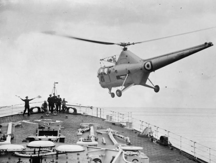 A Westland WS-51 Dragonfly helicopter, a license-built version of the American Sikorsky S-51, landing on the foc’sle of HMS Vanguard
