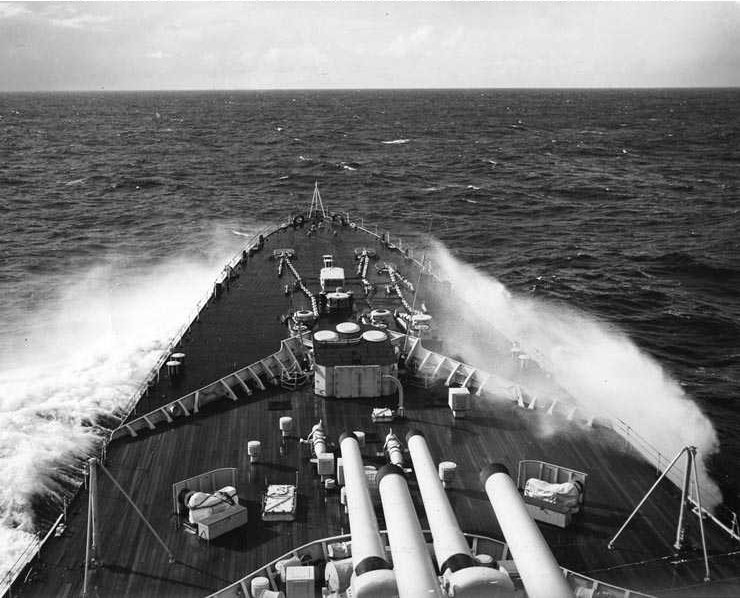 Heavy seas break over the bow of HMS Vanguard during NATO exercise Operation “Mainbrace”, 19 September 1952.