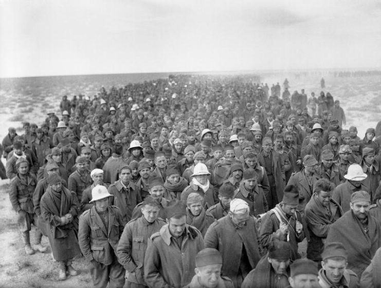 A column of Italian prisoners captured during the assault on Bardia, Libya, march to a British army base on 6 January 1941.